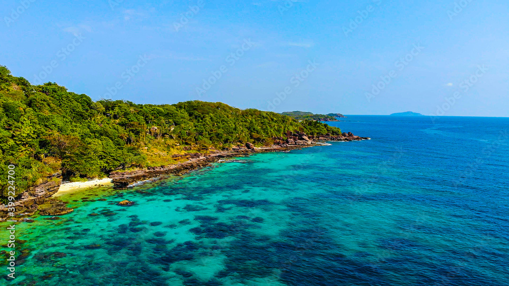 Aerial view of beautiful landscape, tourism boats, and people swimming on the sea and beach on May Rut island (a tranquil island with beautiful beach) in Phu Quoc, Kien Giang, Vietnam.