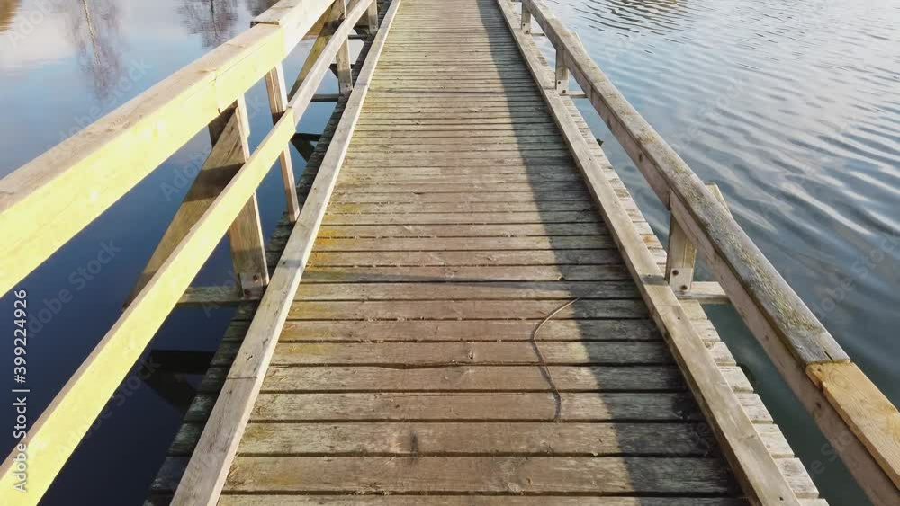 Walking on old wooden bridge in Mellonlahti, Imatra Finland Walking on old wooden bridge in Mellonlahti, Imatra Finland