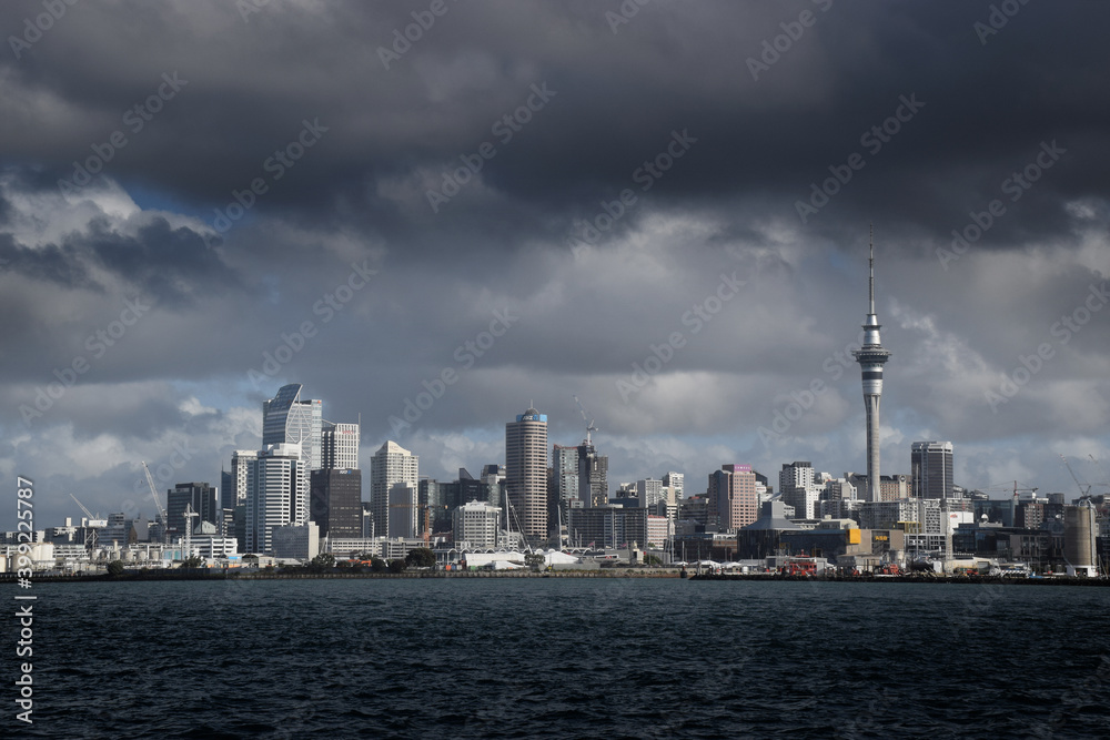 Auckland city skyline with a dark cloud hanging in the sky above