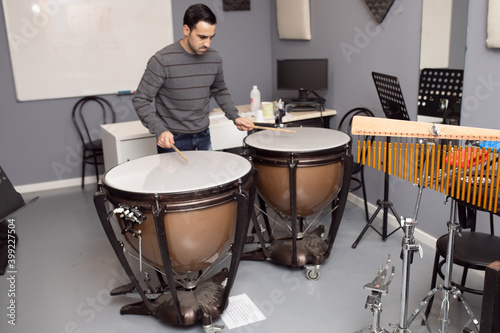 man playing musical instrument orchestral timpani photo