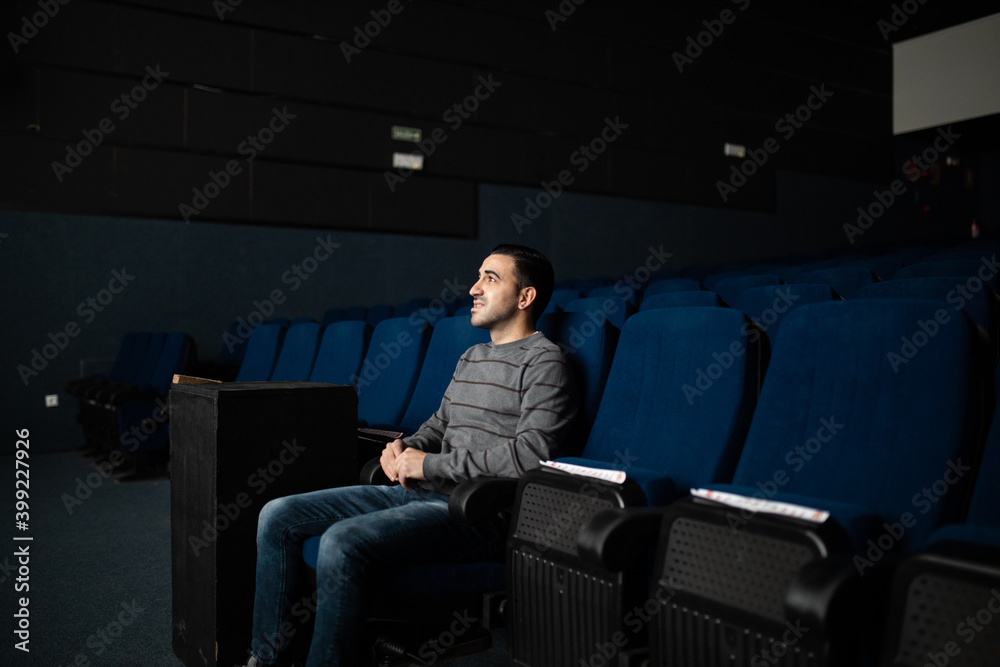 Fototapeta premium man alone watching movie in empty cinema