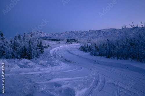 Snow covered twilight landscape with a road in Alaska winter