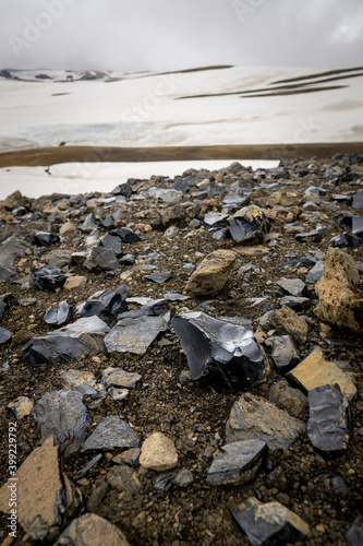 Obsidian volcanic glass scattered on the path of Laugavegur hike in the Rainbow mountains, near Hrafntinnusker hut, Iceland photo