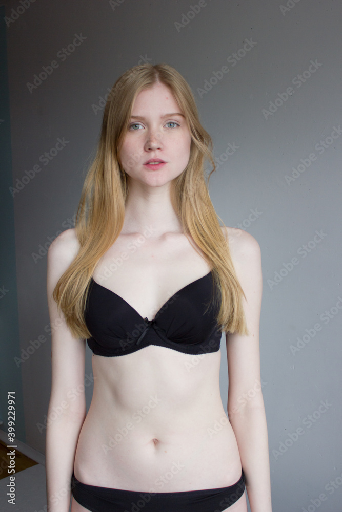 snap shot of pretty model in black lingerie on white background with blonde hair snap shot of pretty model in black lingerie on white background with blonde hair