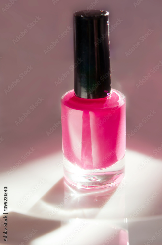 Pink nail polish. Natural hard light, deep shadows. The concept of fashion and beauty industry. - Image Pink nail polish. Natural hard light, deep shadows. The concept of fashion and beauty industry. - Image