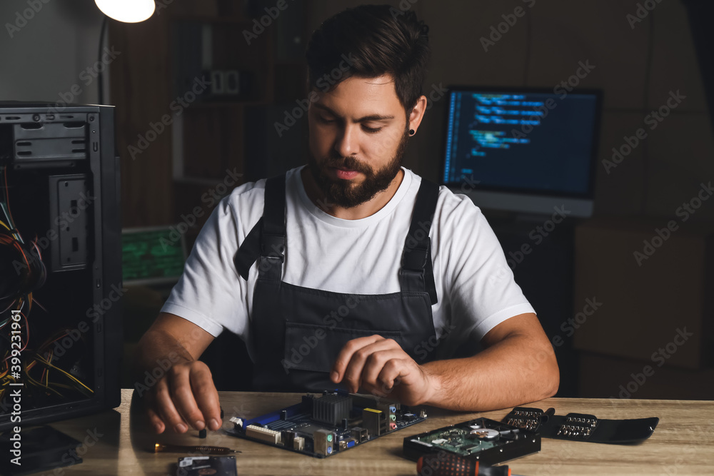 Technician repairing computer in service center Technician repairing computer in service center