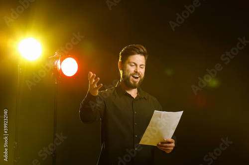 Male actor performing on stage photo