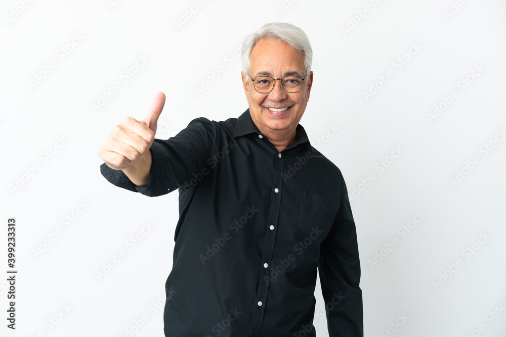 Middle age Brazilian man isolated on white background with thumbs up because something good has happened