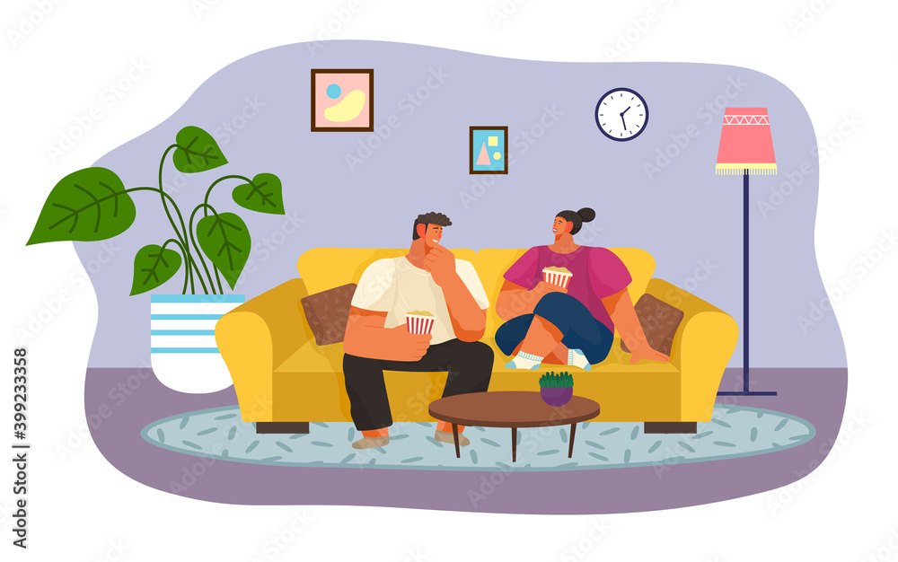 Fototapeta premium Woman and man looking movie at home. People holding popcorn in hands and talking sitting on couch or sofa. Happy couple spending time together at home. People at quarantine isolation at home