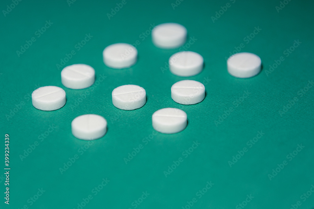 close up. image of tablets on a green background. close up. image of tablets on a green background.