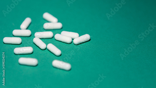 close up. capsules with medicine on a green background.