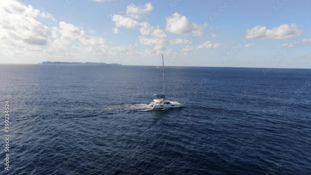 White catamaran sailing on the meditterane sea with a an amazing view of the horizon with blue sea, concept of travel, sun and holiday. White catamaran sailing on the meditterane sea with a an amazing view of the horizon with blue sea, concept of travel, sun and holiday.