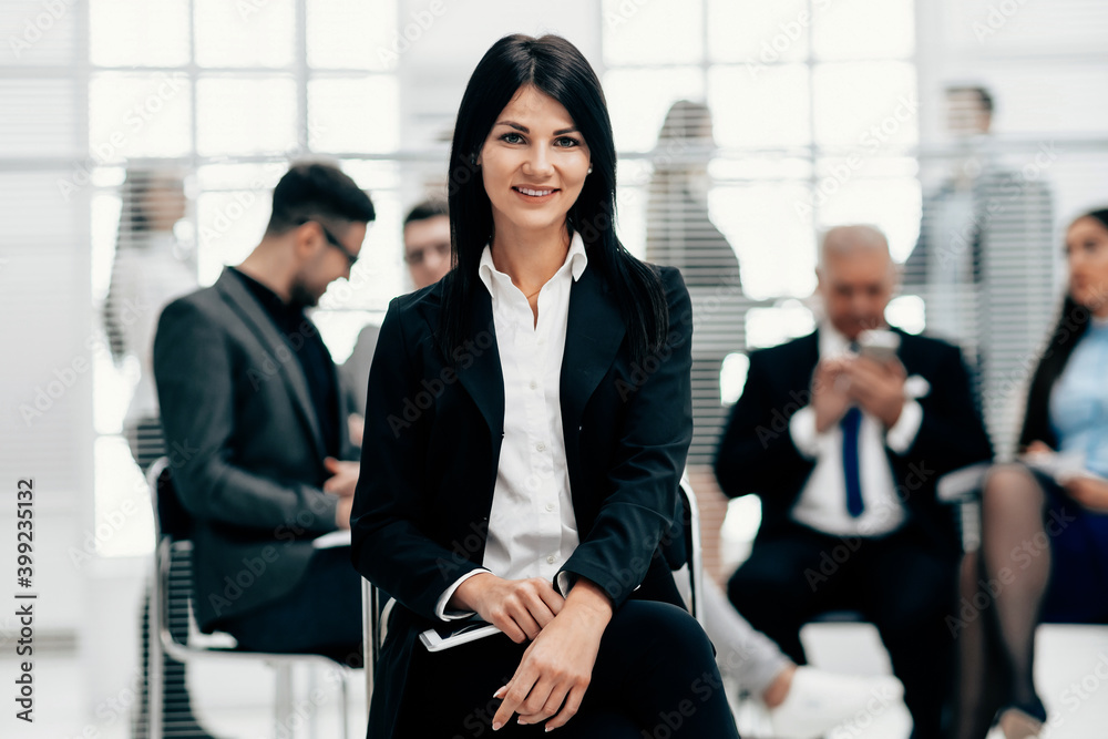 confident young business woman sitting in a modern office confident young business woman sitting in a modern office
