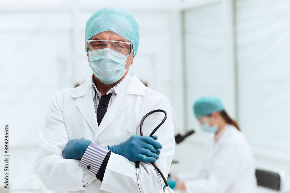 close up. doctor in a protective mask standing in the laboratory.
