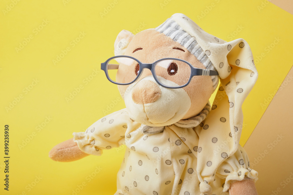 cute teddy bear with glasses on yellow background, trend color