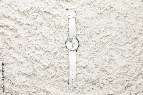 Wrist watch on beach sand © Pixel-Shot