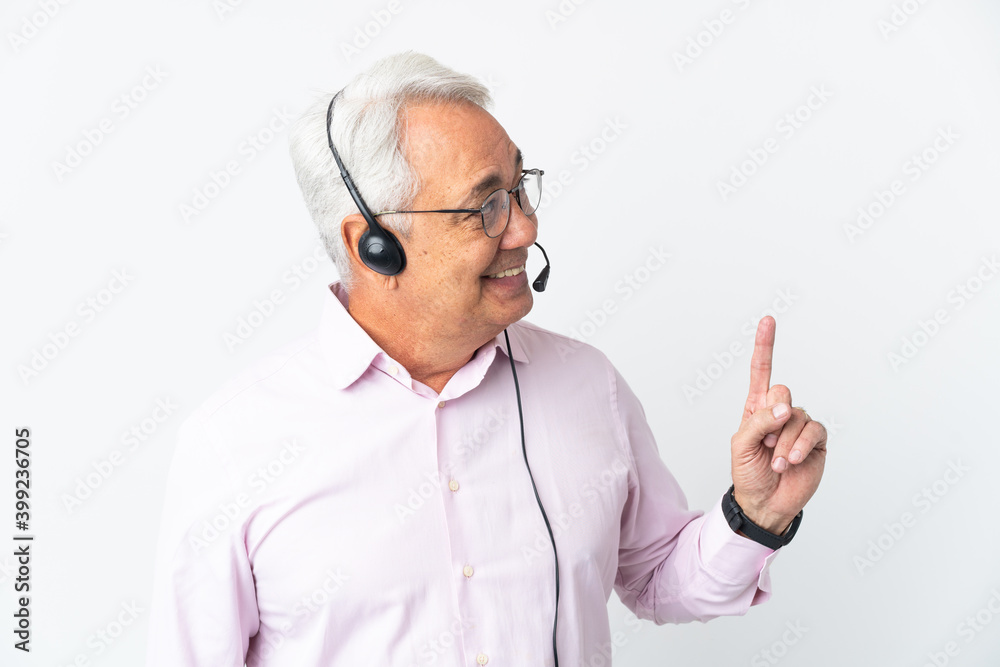 Telemarketer Middle age man working with a headset isolated on white background pointing up a great idea