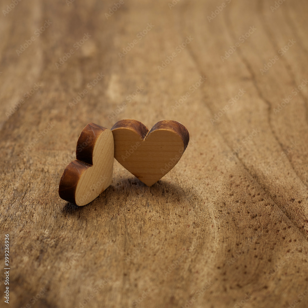 Fototapeta premium wooden hearts placed nicely on wood background