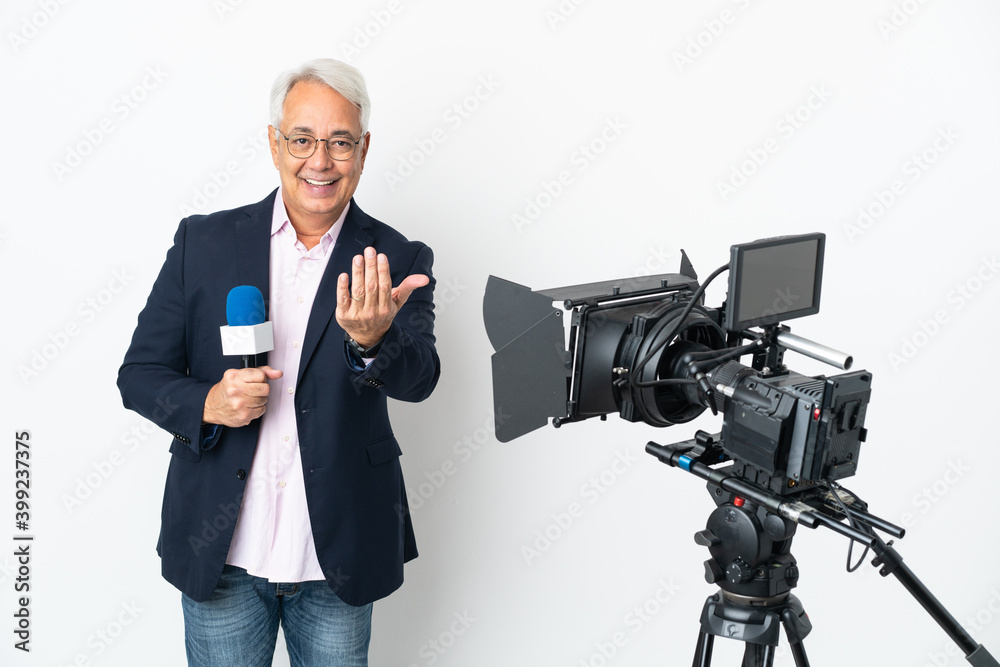 Reporter Middle age Brazilian man holding a microphone and reporting news isolated on white background inviting to come with hand. Happy that you came