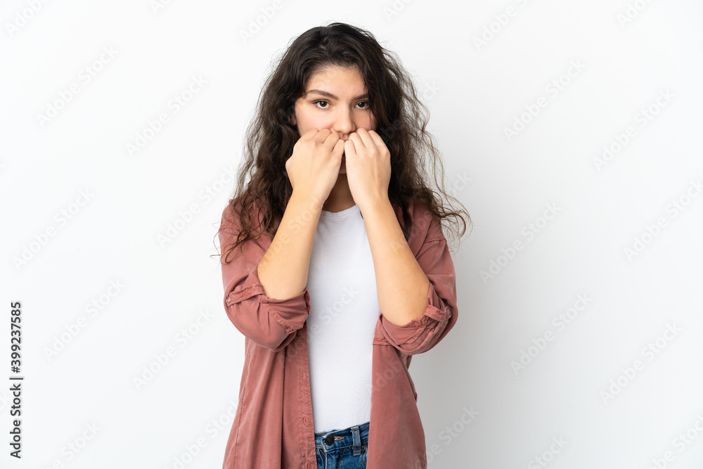 Teenager Russian girl isolated on white background nervous and scared putting hands to mouth