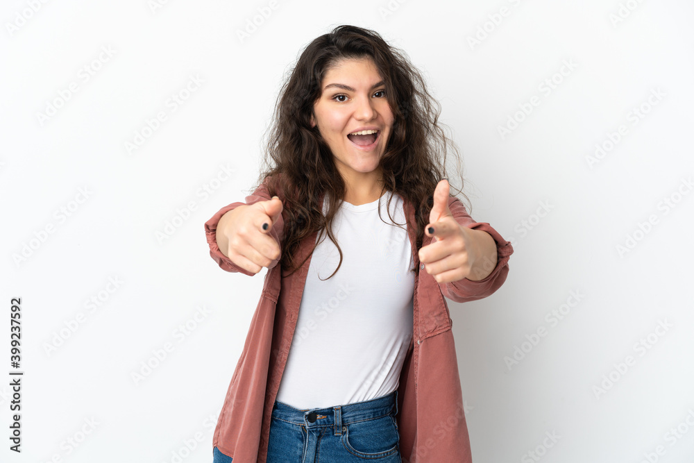 Teenager Russian girl isolated on white background surprised and pointing front Teenager Russian girl isolated on white background surprised and pointing front
