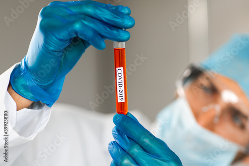 tube with the tested test in the hands of a laboratory assistant .