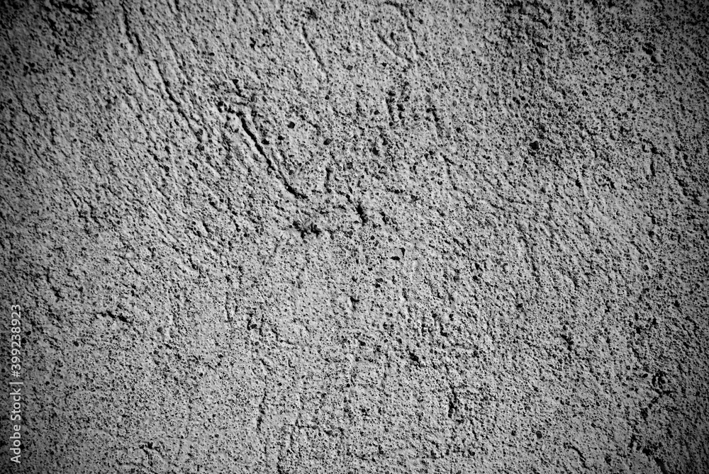 Abstract grungy wall background in a low key. Wall background in black and white. Abstract grungy wall background in a low key. Wall background in black and white.