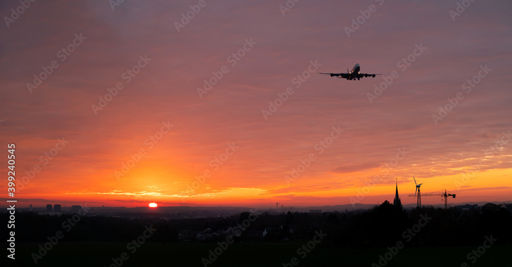 Airplane approaching to Luxembourg airport at sunset.