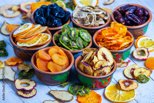 Organic Healthy Assorted Dried Fruit Mix close up. Dried fruit snacks. dried apples, mango, feijoa, dried apricots, prunes top view