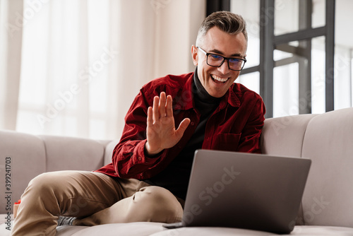 Happy young man on a video call via laptop computer