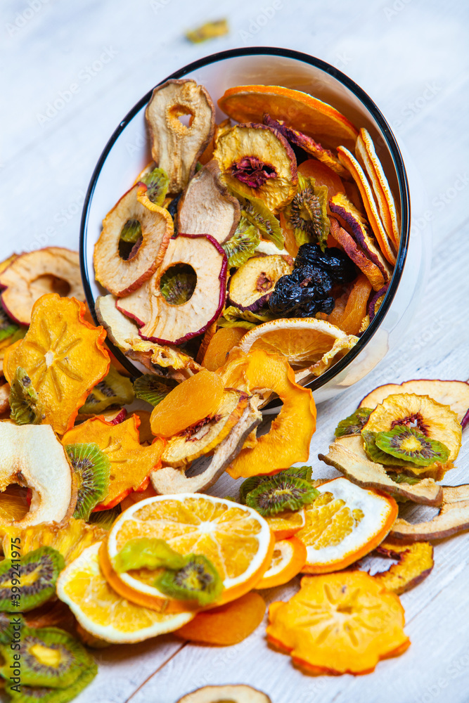 Fototapeta premium Organic Healthy Assorted Dried Fruit Mix close up. Dried fruit snacks. dried apples, mango, feijoa, dried apricots, prunes top view