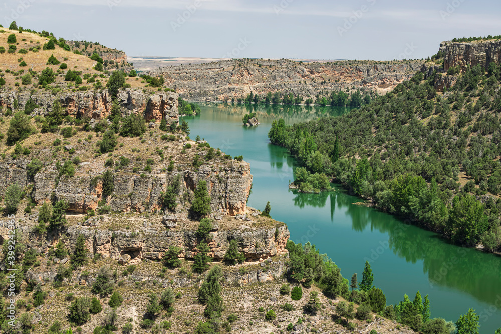 Passage of the Duraton river reflecting its impressive cliffs. Photograph taken in Segovia, Spain.