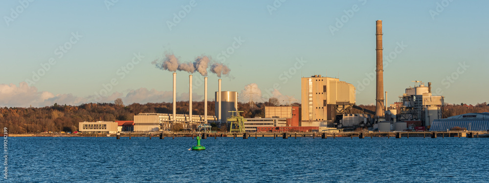 Fototapeta premium Panoramaaufnahme über die Kieler Förde zum Ostuferhafen mit dem alten Kohle und dem neuen modernen Gas-Wärmekraftwerk