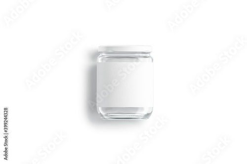 Blank glass jar with white label and cap mockup lying photo