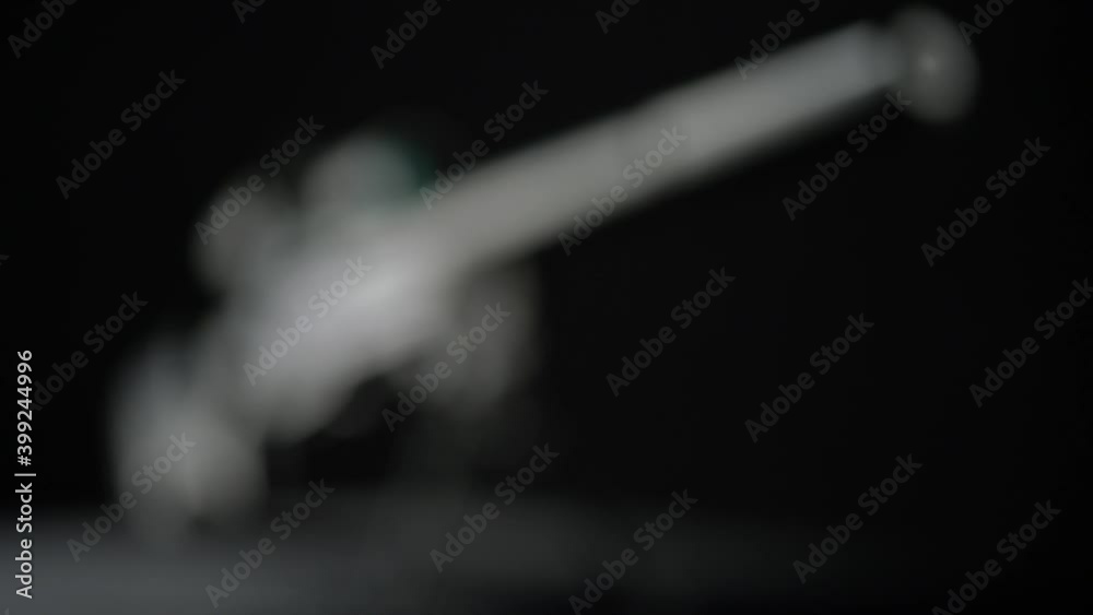 focus and movement from the butt of the silencer to the top of Sniper rifle Sako TRG 41 on black background focus and movement from the butt of the silencer to the top of Sniper rifle Sako TRG 41 on black background