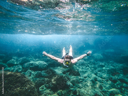 man dives into the sea. guy underwater