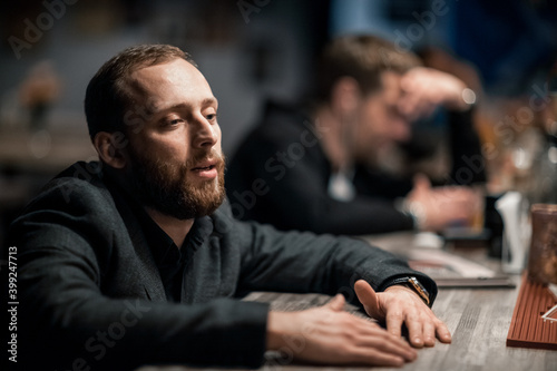 Portrait of a handsome young man. Shooting in a bar