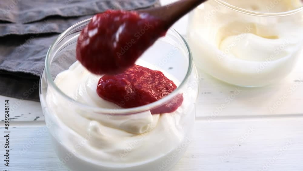 Yogurt in a jar with berry jam. Healthy breakfast concept.
Yogurt in a jar with berry jam. Healthy breakfast concept.