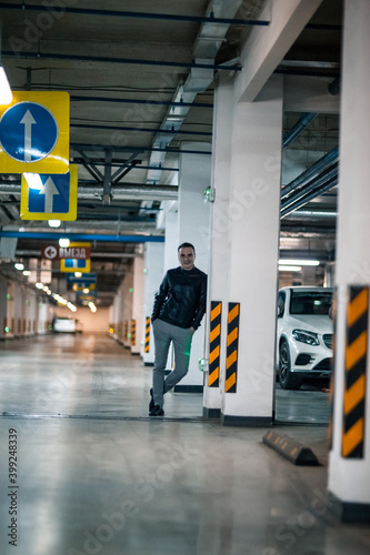 Portrait of a handsome young man. Shooting in a car park