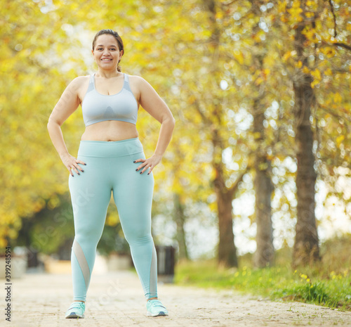 Fat woman jogging, doing sports for weight loss, obesity problem. High quality photo.