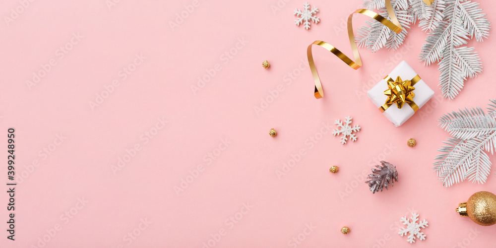 Golden christmas decoration on pink background with copy space