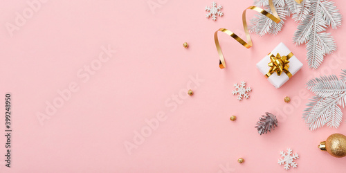 Golden christmas decoration on pink background with copy space © fotomaximum
