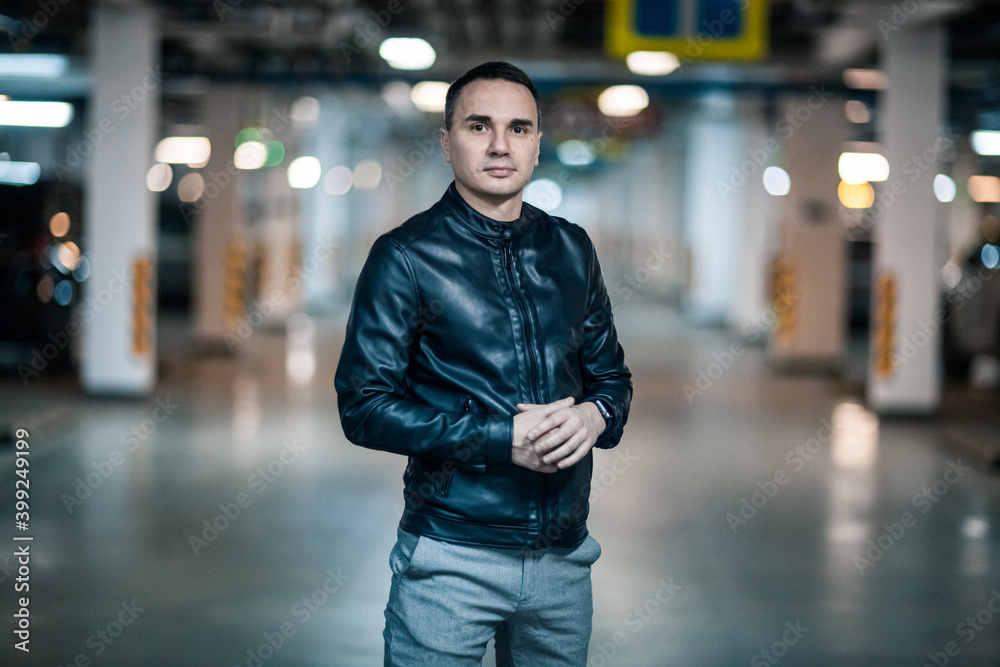 Fototapeta premium Portrait of a handsome young man. Shooting in a car park