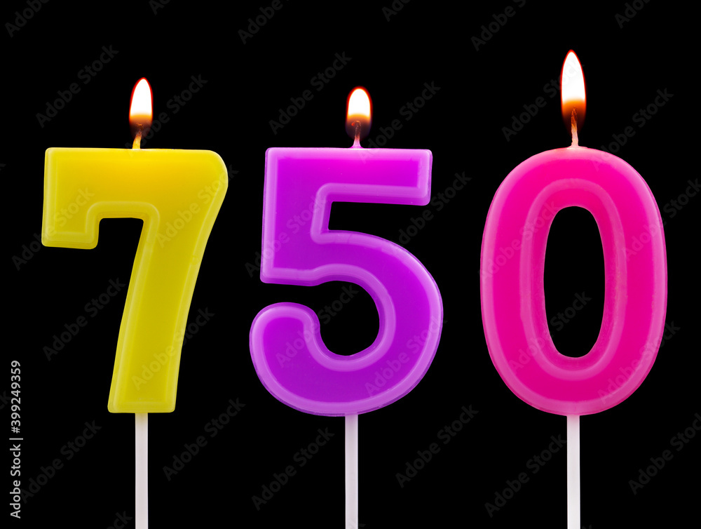 Burning birthday candles isolated on black background, number 750 Burning birthday candles isolated on black background, number 750