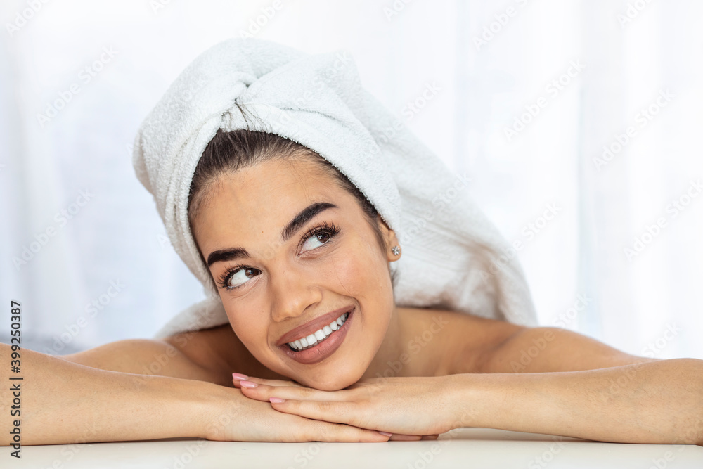 Attractive smiling young woman with perfect skin. Closeup portrait of an attractive mid 30's woman gently touching her face and smiling while looking at the camera and sincerely smiling. Attractive smiling young woman with perfect skin. Closeup portrait of an attractive mid 30's woman gently touching her face and smiling while looking at the camera and sincerely smiling.