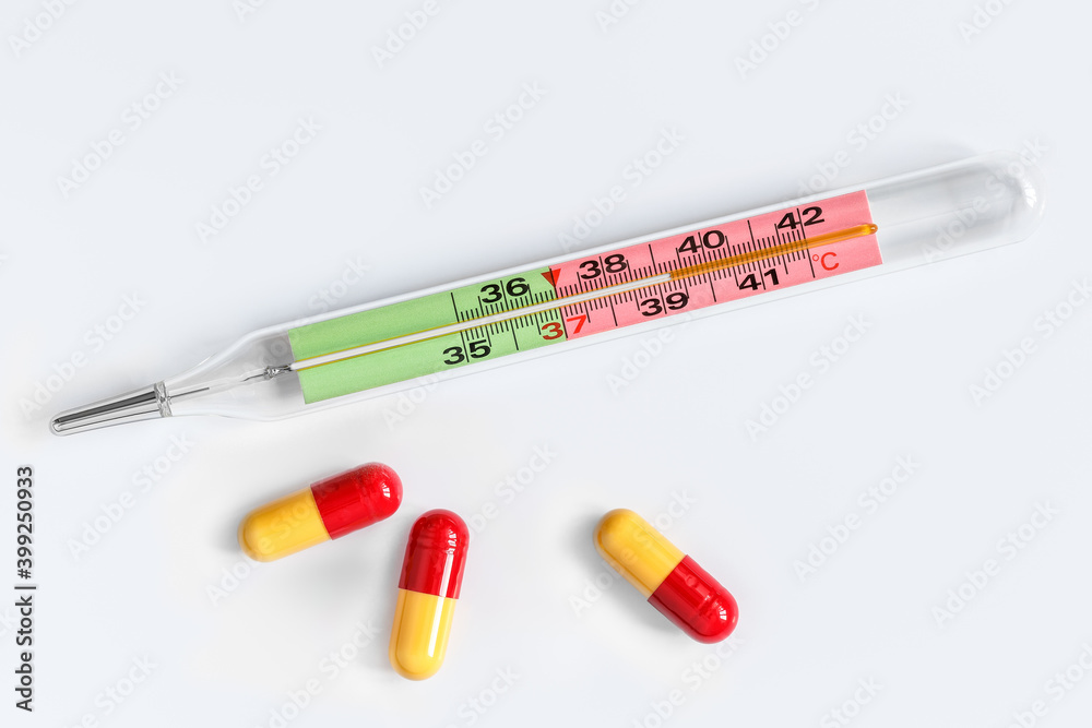 Mercury thermometer and three medicine capsules Mercury thermometer and three medicine capsules