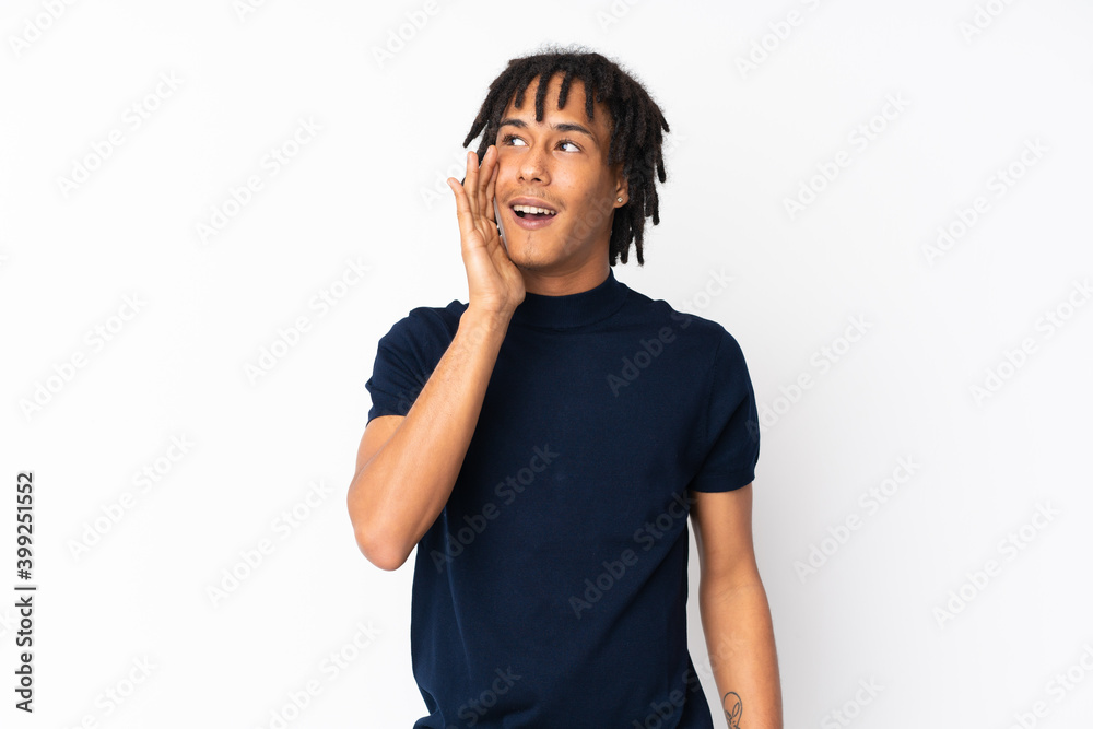 Young african american man isolated on white background shouting with mouth wide open to the lateral Young african american man isolated on white background shouting with mouth wide open to the lateral