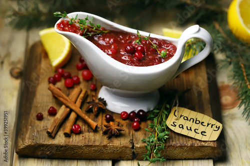 Fototapeta Naklejka Na Ścianę i Meble -  Homemade cranberry sauce in a gravy boat. Festive food. Christmas mood.