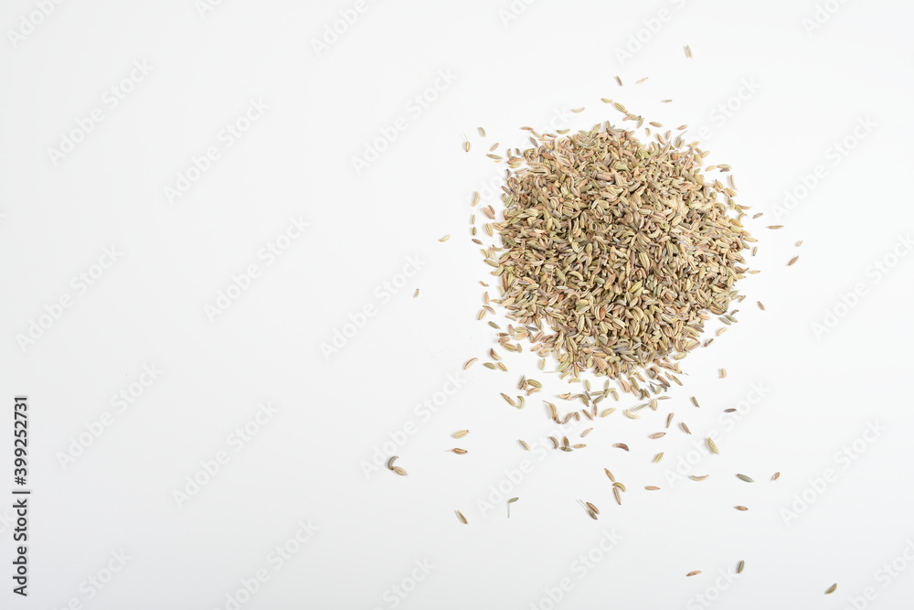 fennel seeds scattered on a plain white sheet fennel seeds scattered on a plain white sheet