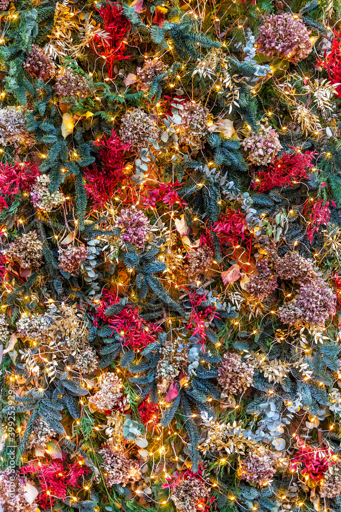 Christmas holiday season decorations background with natural plants, flowers and lights; vertical. Christmas holiday season decorations background with natural plants, flowers and lights; vertical.